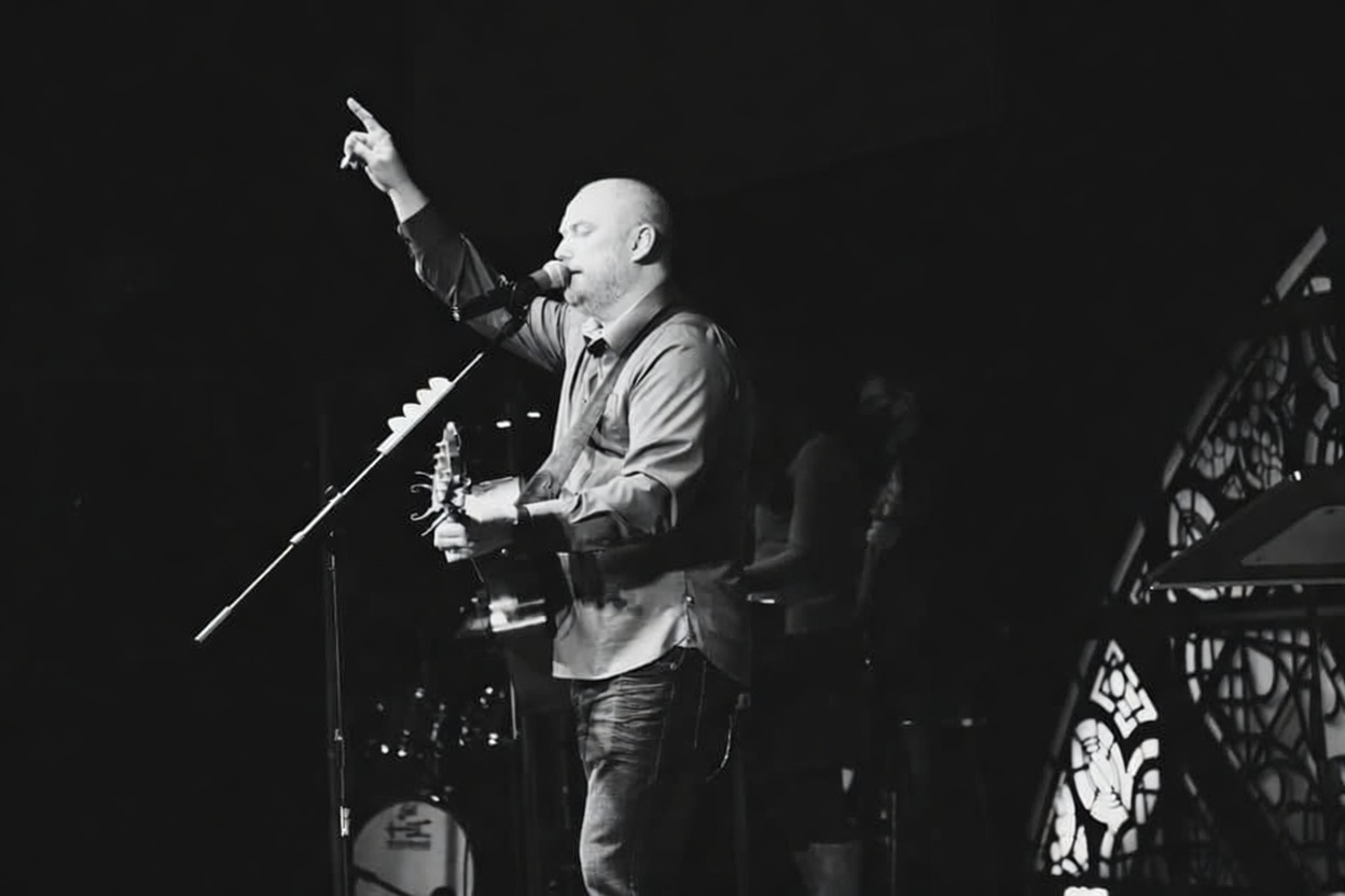 Joe performing vocals and guitar