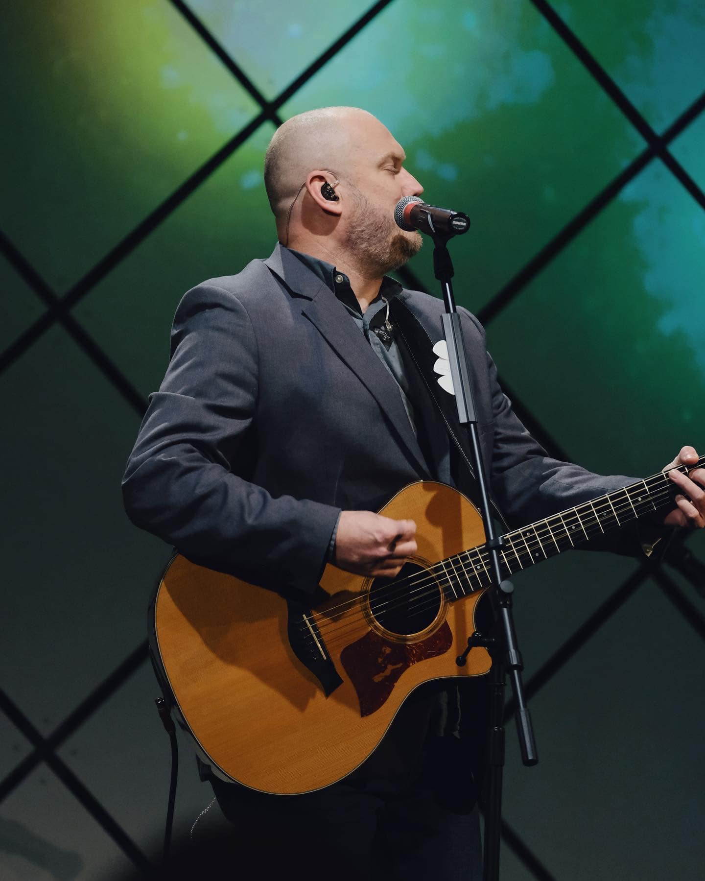 Joe on stage with acoustic guitar